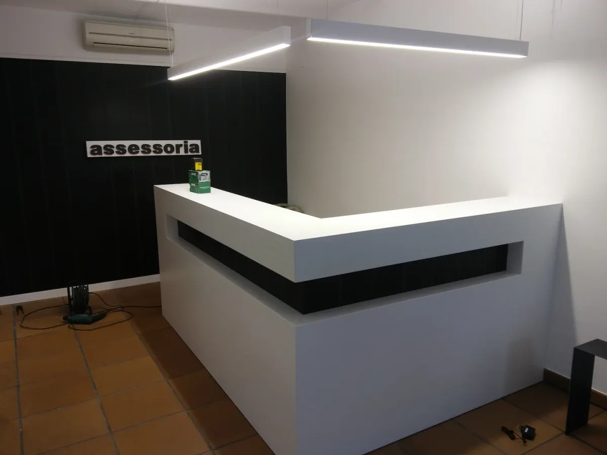 Taulell de recepció blanc a mida amb llum LED, instal·lat en una assessoria